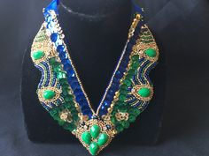 "Stunning hand embroidered bib necklace: * Truly unique statement piece for special occasions, festivals, weddings. * Intricately beaded design with emerald green, blue and gold seed beads and sequins. * Focal pieces are emerald green stones which bring the whole design together. * Necklace measures 6 1/4\" long and 6\" across. * Brilliant blue ribbon closure allows for adjustable length and adds uniqueness to this one of a kind piece. **Free Shipping**" Peach Necklace, Emerald Green Stone, Statement Bib Necklace, Bib Necklaces, Black Chain, Bib Necklace, Green Crystals, Wire Jewelry, Crystal Earrings