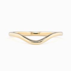 a gold and silver ring with wavy lines on it's sides, against a white background