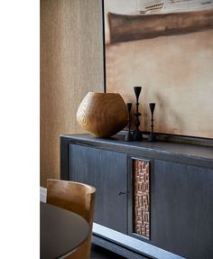 a wooden object sitting on top of a black cabinet