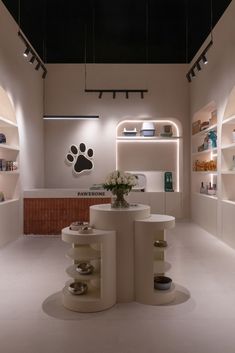 the interior of a pet store with white walls and shelves filled with dog paw prints