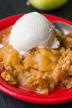 a red plate topped with a scoop of ice cream next to an apple crispet