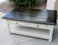 a white coffee table with two drawers on it