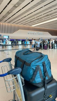 luggage sitting on top of a cart in an airport