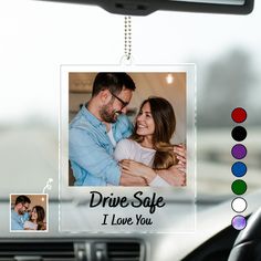 a photo hanging from the dashboard of a car with two photos attached to it that says drive safe i love you