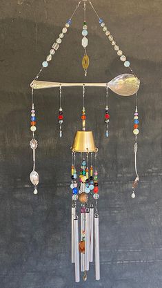 a wind chime hanging from the ceiling with beads and other things attached to it