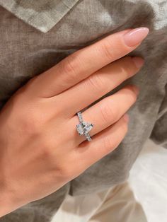 a woman's hand with a diamond ring on it