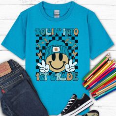 Go back to school in style with this "Rollin Into 1st Grade" shirt! Our kids heavy cotton tee is perfect for everyday use. The fabric is 100% cotton for solid colors. Polyester is included for heather-color variants.  ** HOW TO ORDER ** Select size + color from the drop down menus Add to cart + place order  ** SIZING ** Please refer to sizing charts for accurate measurements.  ** SHIPPING ** Ships in 2-5 business days ** ABOUT OUR SHIRTS ** * Gildan Brand * Solid Colors: 100% Cotton * Heather Co Blue Pre-shrunk T-shirt For School Events, Casual Letter Print T-shirt For School Events, Retro Crew Neck T-shirt For School, Blue Graphic Print T-shirt For School Events, College Style Short Sleeve T-shirt For School, School T-shirt With Graphic Print And Relaxed Fit, Blue College Style T-shirt For Streetwear, Relaxed Fit Graphic Print T-shirt For School, Casual Relaxed Fit T-shirt For Back To School