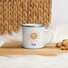 a close up of a coffee cup on a table with cookies and a basket in the background