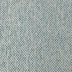 an upholstered blue and white fabric textured with small squares in rows,