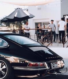 a black car parked in front of a restaurant