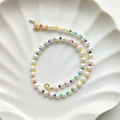 ✋100% HANDMADE 🌞 Natural freshwater pearl and multicolor seed beads necklace, very bright, very sunny, suitable for summer! 📏SIZE: 44cm long / 17 inch * If you need other lengths, please contact me or leave a message in the order. 📿 MATERIAL: 6-7mm freshwater pearls 3mm glass beads 14K gold plated clasp closure 📦 Packaging: 🔆 All comes in a beautifully packaged cotton pouch ready to be gifted. * If you have any ideas about packaging, please feel free to contact me. ✈️ Shipping and Delivery: Dainty Pearl Beaded Necklaces For Summer, White Beaded Pearl Necklace For Summer, White Pearl Beaded Necklace For Summer, Summer White Pearl Beaded Necklace, White Beaded Necklaces With Pearl Chain For Summer, White Pearl Chain Beaded Necklaces For Summer, White Pearl Chain Beaded Necklace For Summer, Summer White Pearl Beaded Necklaces, Summer White Beaded Necklace With Pearl Chain