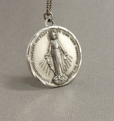 Check out this item in my Etsy shop https://www.etsy.com/listing/690111074/lrg-vintage-sterling-immaculate-mary Vintage Nickel Free Necklaces For Commemoration, Personalized Vintage Jewelry For Commemoration, Collectible Jewelry With Miraculous Medal Round Pendant, Vintage Charm Necklaces For Commemoration, Vintage Charm Necklace For Commemoration, Vintage Charms Necklace For Commemoration, Collectible Round Miraculous Medal Jewelry, Vintage Round Necklace With Miraculous Medal, Mary Necklace Silver