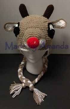 a crocheted deer hat with red nose and horns