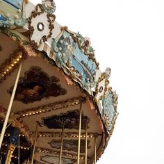 an ornately decorated merry go round on a cloudy day