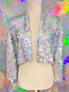 Perfect for music festivals and nights out with friends! All jackets are handmade with love and ready to ship in 1-3 days. Size chart in photos. Crop jacket length 16-18 inches. If you would like a custom Size/ Length, color, and lining please use this link below. DESIGN YOUR OWN * Custom Confetti Jacket *More colors available! https://www.glittertrove.com/listing/1028062548/custom-size-sword-sequin-jacket-sequin Please advise, Must be worn with care. Sequins may fall out if tugged or worn rough Tinsel Jacket, Glitter Jacket, 70s Jacket, Sequin Kimono, Custom Confetti, Silver Holographic, Sequin Blazer, Disco Outfit, Sequin Jacket