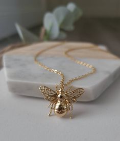 This listing is for a beautiful 14K gold filled Bee Charm Necklace! This stunning bee pendant comes on a 16, 17.5 or 19 inch cable chain. A 2 inch extender can be added. This piece will not tarnish, fade or flake! This unique bee pendant necklace is fun, cute, and perfect for spring and summer! Bee measures 2cmx2.5cm See listing for matching earrings here https://www.etsy.com/listing/984786778/14k-gold-filled-bee-earrings-bumble-bee?ref=shop_home_feat_3 W H A T ∙ I S ∙ G O L D ∙ F I L L E D? Gol Honey Bee Jewelry, Fantasy Earrings, Bee Jewelry, Bee Pendant, Gold Bee, Snake Jewelry, Bee Necklace, Bee Earrings, Gold Jewelry Necklace