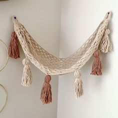 there is a hammock hanging on the wall with tassels around it