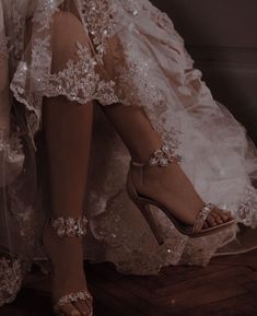 a woman's legs in high heeled shoes with beaded lace on them