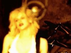 a blurry image of a blonde woman standing next to a bike