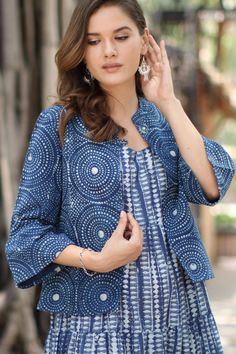 Using the traditional block-printing technique, Indian artisans decorate this cotton jacket with mesmerizing circle motifs in indigo and snow white. Jay Kumar Maheswari designs this lovely jacket, which closes at the neckline with a button.