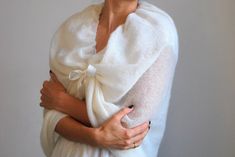 Wedding cape shawl, wedding wrap mohair, bridal scarves shawl, wedding shawl ivory, bridal shawl cape, women scarf shawl, bridal shawl knit This light ivory wedding shawl is made of soft kid mohair and silk yarn. (75 % soft mohair and 25 % silk). It will look good with any type of clothing for many occasions: wedding, theater, garden party, birthday party. Lovely, breeze and comfortable, long and wide knitted natural scarf/shawl/wrap. Measurements: Width: 70 cm = 27.5 inches Measurements can be Elegant Wrap Scarves For Winter, Elegant White Pashmina Shawl, Elegant White Lace Shawl, Wedding Scarf Wrap Shawl, White Shawl Wrap For Wedding, Wedding Shawl Wrap Scarf, Elegant Handmade Mohair Shawl, Elegant Handmade Shawl As Gift, Elegant Winter Shawl Wrap