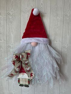 a red and white santa hat hanging on the wall