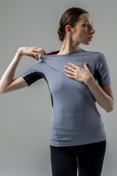 Design. Grey women's rash guard t-shirt with an anatomical fit. Tight, secure fit on the body. Seam placement provides maximum comfort for wide amplitude movements of arms and torso. Grey dance stretch T-shirt for women. Material. Italian biflex - elastic, highly durable, dries quickly, doesn't deform. NB Sweat is less visible on more vibrant and darker colours. Design and technology consider the intensity of dancing and sport activities. Fitted Gray T-shirt For Sports, Fitted Athleisure T-shirt For Training, Fitted Gray Moisture-wicking Activewear, Sporty Stretch Rash Guard With Thumbholes, Fitted Sporty Rash Guard With Thumbholes, Sporty Fitted Rash Guard With Thumbholes, Fitted Gray Activewear With Light Support, Gray Fitted Activewear With Light Support, Fitted Sportswear Tops With Light Support