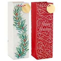 two red and white boxes with christmas decorations on them, one has a gold tag that says happy holidays