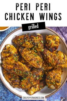 grilled chicken wings in a bowl with text overlay that reads peri peri chicken wings grilled