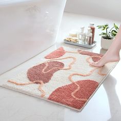 a bathroom rug that has a woman's feet on it