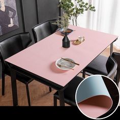 a pink table with black chairs and a painting on the wall in the back ground