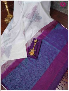 A pristine white soft silk saree featuring a tableau of butterfly patterns half adorned in royal purple threads and half in serene blue threads. The charming butterfly motifs dance across the fabric, creating a mesmerizing blend of grace and vibrancy. This borderless ethereal white saree leads to a captivating purple pallu that intricately unfolds into a tapestry of enchanting floral designs woven with delicate blue threads. This elegant combination captures the essence of sophistication, blendi White Tussar Silk Saree With Traditional Patterns, White Silk Handloom Traditional Wear, White Tussar Silk Saree For Traditional Ceremonies, White Cotton Silk Dupatta With Traditional Patterns, White Silk Dupatta With Traditional Patterns, White Traditional Wear With Motifs In Cotton Silk, White Art Silk Saree With Traditional Patterns, White Katan Silk Saree With Traditional Patterns, White Silk Saree With Zari Weaving