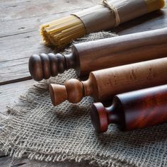 three wooden rollers sitting next to each other on top of a burlock