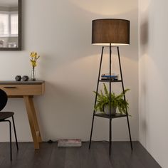 a room with a desk, chair and lamp on it in front of a mirror