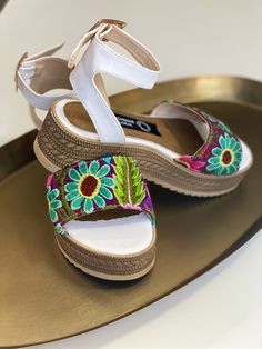 Multicolor embroidery, white leather sandal. Every embroidery is unique and is not identical to any other pair. Colors and embroidery will vary. Embroidery will no be the same as picture shown. Made in Mexico City Traditional White Sandals For Summer, White Closed Toe Sandals For Festivals, Casual Embroidered Huarache Sandals For Spring, White Embroidered Closed Toe Sandals, Bohemian Multicolor Embroidered Sandals, Traditional White Round Toe Sandals, Multicolor Embroidered Open Toe Sandals, Casual Embroidered Open Toe Huarache Sandals, Embroidered Multicolor Open Toe Sandals