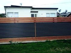 a wooden fence in front of a house