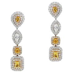 A Tri-Tone Multi-Color Mixed-Shape Diamond Dangling Earrings made in 18k yellow gold. The total diamond weight is appx. 1.72 carats. The length of the earring is 1.25 inches. The total weight is 8.49 grams. Yellow Diamond Baguette Cut Jewelry, Luxury Yellow Diamond Cut Earrings, Yellow Diamond Earrings In Fine Jewelry Style, Fine Jewelry Yellow Diamond Earrings, Yellow Baguette Cut Diamond Jewelry, Yellow Diamond Earrings With Diamond Accents, Yellow Diamond Earrings With Diamond Accents For Wedding, Yellow Diamond Earrings With Accents For Wedding, Wedding Yellow Diamond Earrings With Accents