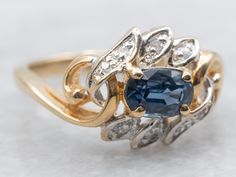 This retro style ring boasts a stunning oval cut blue sapphire, complimented by sparkling diamond accents. With its whimsical design, this ring adds a touch of vintage charm to any outfit. Perfect for the modern woman who appreciates classic elegance. Metal: 14K Yellow GoldGem: Sapphire .75 CaratsGem Measurements: 6.2 x 4.3 mm, OvalAccents: 8 Diamonds totaling .04 Carats, I1 in Clarity, H in ColorRing Size: 5.75Marks: “14K PUN” Stamped on the inside band Right Hand Ring, Ring Sapphire, Right Hand Rings, Sparkling Diamond, Hand Ring, Whimsical Design, Ring Oval, September Birthstone, Color Ring