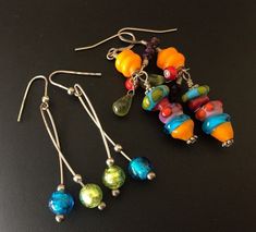 These two bright colorful bead pierced earrings have a mix of bright beads on sterling silver wires. The bright blue and green ones hang on sterling silver wires that are stamped 925. They are 2 1/4 inches tall from the top of the wire and 3/4 inch wide. The multicolored bead earrings have a mix of hand blown beads and glass bead highlights. They are 2 1/2 inches tall and 3/4 inch wide. Both are bright and fun and festive. I specialize in finding fun wearable jewelry. Please browse my shop for m Vibrant Blue Dangle Earrings, Vibrant Green Dangle Earrings, Vibrant Dangle Earrings With Ear Wire, Sterling Silver Earrings With Colorful Round Beads, Multicolor Wire Wrapped Sterling Silver Earrings, Multicolor Dangling Beads Earrings In Sterling Silver, Multicolor Dangling Beads Sterling Silver Earrings, Nickel Free Multicolor Beaded Sterling Silver Earrings, Multicolor Sterling Silver Beaded Earrings For Pierced Ears