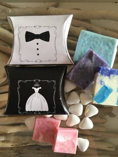 soaps and marshmallows are arranged on a wooden surface with the image of a bride in a tuxedo