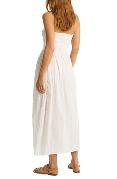 This strapless cover-up dress is crafted of from cotton and designed with a smocked bodice that leads to a flowy skirt. 44" center front length (size Medium) Slips on over head Strapless Smocked bodice 100% cotton Hand wash, dry flat Imported Summer Strapless Ruched Tube Top, Bandeau Tube Top With Smocked Back For Beach, Spring Cotton Tube Top With Smocked Back, Strapless Beach Tube Top With Smocked Back, Strapless Tube Top With Smocked Back For Beach, Ruched Tube Top For Beach In Spring, Strapless Smocked Bodice Tube Top For Beach, Strapless Maxi Dress With Smocked Back For Beach, Spring Beach Tube Top With Smocked Bodice