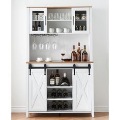 a white cabinet with wine glasses and bottles