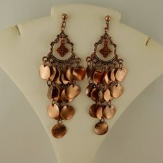 Bronze Metal Pierced Chandelier Earrings, Bronze Metal Dangle Chandelier Earrings, Nickel-free Bronze Chandelier Earrings, Bronze Metal Teardrop Dangle Earrings, Bronze Metal Dangle Teardrop Earrings, Elegant Copper Chandelier Dangle Earrings, Copper Chandelier Dangle Earrings For Pierced Ears, Metal Chandelier Earrings With Dangling Charms As Gift, Bronze Dangle Chandelier Earrings