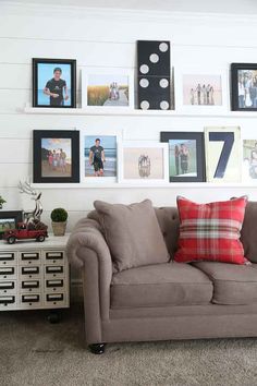 a living room filled with furniture and pictures on the wall