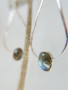 This pair of Handmade Earrings feature a gorgeous Labradorite with beautiful flash, bezel set with a delicate teardrop shape of the sterling silver wire. The earring frame has little hammered detail with a dark patina accent.  A classic piece, these earrings will compliment any outfit! Each piece of GreenHillJewelry is handmade in our El Dorado Hills, CA studio. We proudly use Recycled Sterling Silver. Please allow for natural variations that may occur. This order will ship in 1-2 business days via first class USPS unless Priority Shipping is added at checkout. Everyday Teardrop Jewelry With Bezel Setting, Sterling Silver Gemstone Teardrop Pendant Earrings, Minimalist Teardrop Jewelry With Bezel Setting, Minimalist Teardrop Bezel Set Jewelry, Sterling Silver Gemstone Teardrop Earrings, Sterling Silver Long Drop Teardrop Gemstone Earrings, Silver Gemstone Teardrop Long Drop Earrings, Silver Long Drop Teardrop Earrings With Gemstone, Elegant Labradorite Teardrop Earrings