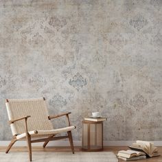 a chair sitting on top of a wooden floor next to a table with an open book