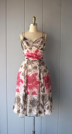 This dress is stunning. I imagine this dress being worn in Paris while roaming through the museums and gardens. It's silk chiffon with a floral painted print in pinks and brown/taupe colors. It's flowing and light and you'll feel SO pretty in this! Fitted waist line, boning on the sides o the bust (within the slip), a gorgeous sweetheart neckline with gathering chiffon just below the bust. There are double arm straps and a hidden zipper in the back. The dress also has a triple layered skirt slip Vintage Silk Dress With Floral Print, Silk Dress With Sweetheart Neckline For Garden Party, Fitted Silk Chiffon Dress For Garden Party, Vintage Pink Chiffon Dress, Spring Garden Party Silk Chiffon Dress, Vintage Silk Chiffon Dress For Summer, Vintage Silk Chiffon Summer Dress, Spring Floral Print Silk Chiffon Dress, Spring Silk Chiffon Floral Print Dress