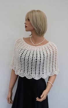 a mannequin wearing a white crochet top with pearls on the neck