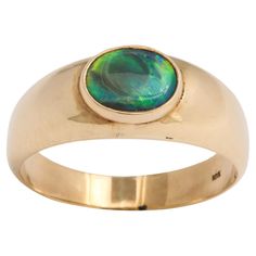 Set with a natural oval black opal of warm ocean blue green color this ring is nature showing its most rare of the opal family. There is a spectrum of color in this Australian opal, a dark tone with flashings within of dark and light shades of green, blue and black. It is vibrant to the eye and the color resounds in your core. Australian black opals were first removed from a ridge in the 1901. Ancient Greeks believed the stone kept its owner from disease. The European population tagged the black opal as a symbol of purity, hope and truth. he Opal stone represents amplification, higher hope, and divine purity. These light dancing gemstones are here to boost those feelings of balance and peace and to help you to sift through your thoughts and feelings and throw out what doesn't work. Spiritu Australian Black Opal, Black Opal Ring, Blue Green Color, Opal Stone, Australian Opal, Opal Ring, Black Opal, Ocean Blue, Opal Rings