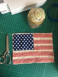 the american flag is next to a pair of scissors and a container with sprinkles on it